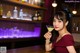 A woman in a red dress holding a martini glass.