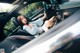 A woman sitting in the driver's seat of a car.