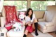 A woman sitting on a couch with stuffed animals.